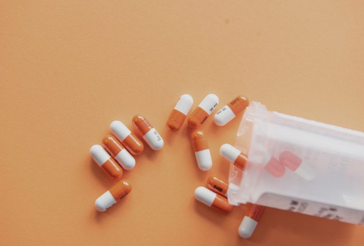 Orange and white capsules of medicine.