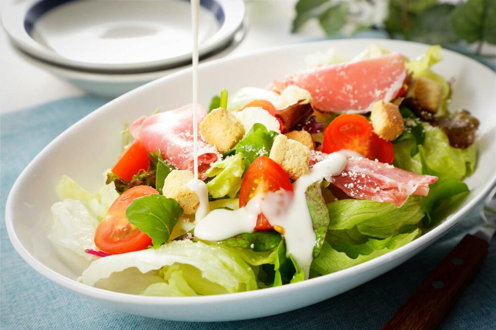 Bowl of salad with dressing.