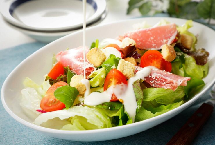 Bowl of salad with dressing.