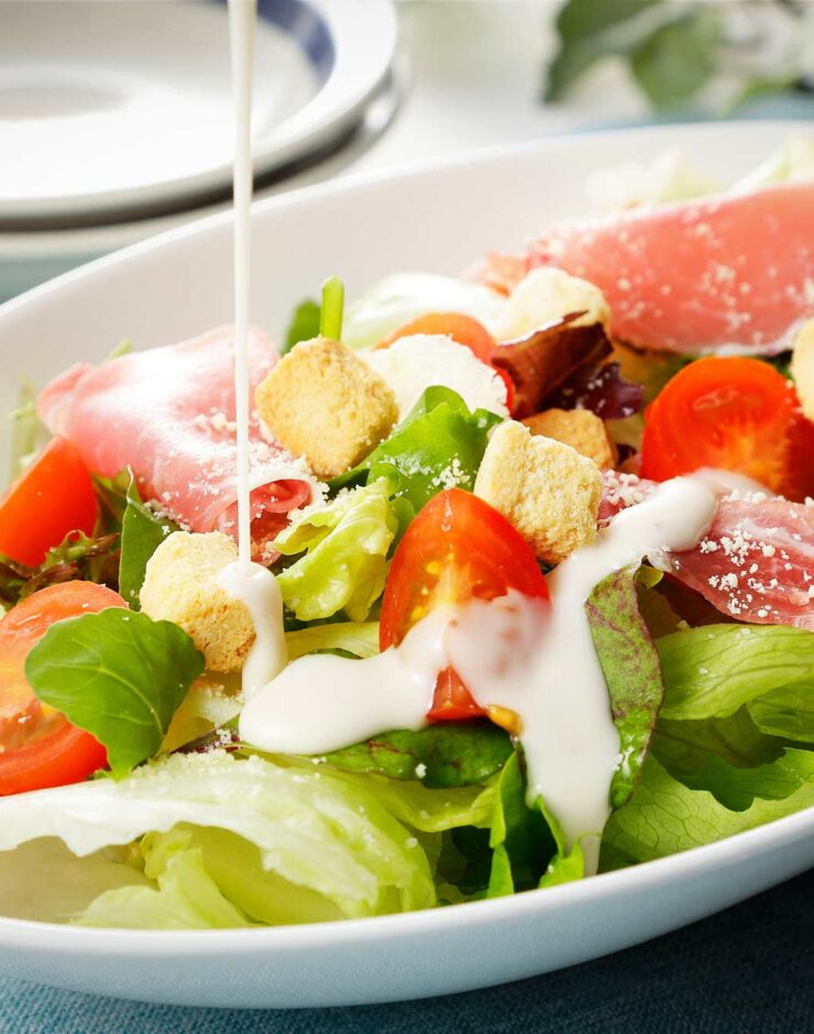 Bowl of salad with dressing.