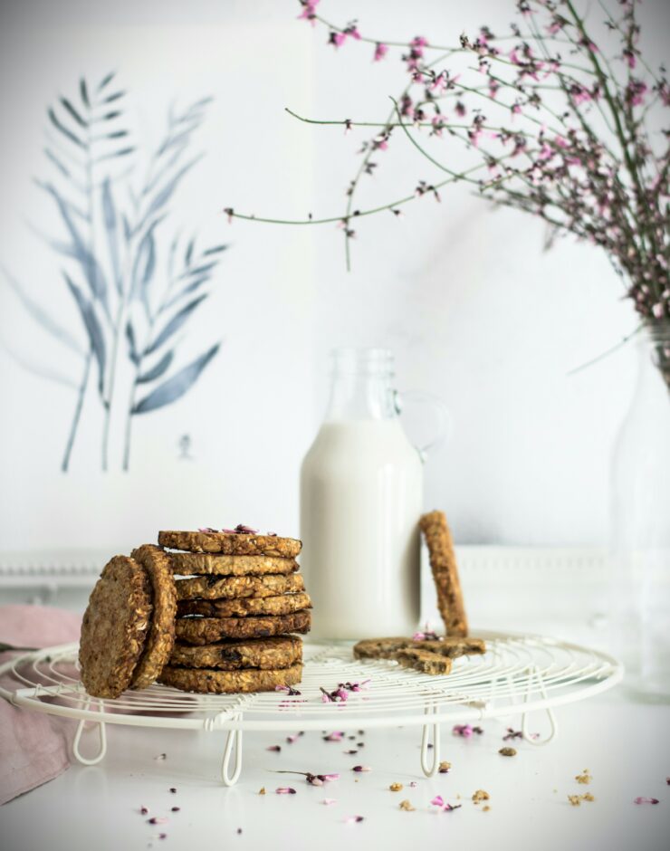 Glass bottle of milk with oat biscuits.