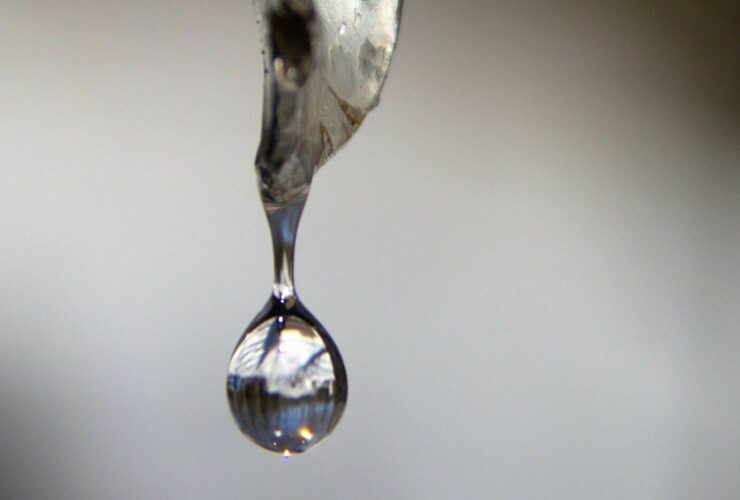 Clear syrup being poured out.