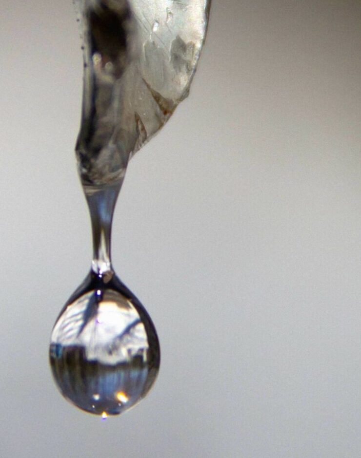 Clear syrup being poured out.