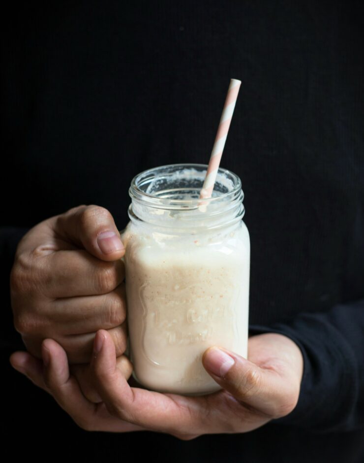 Man holding a vegan milkshake.