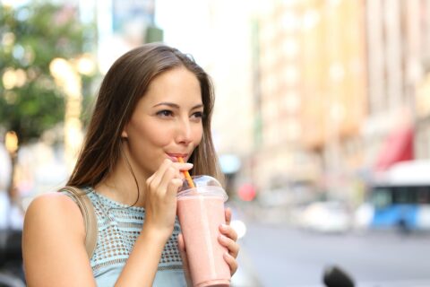 Woman drinking a smoothie.